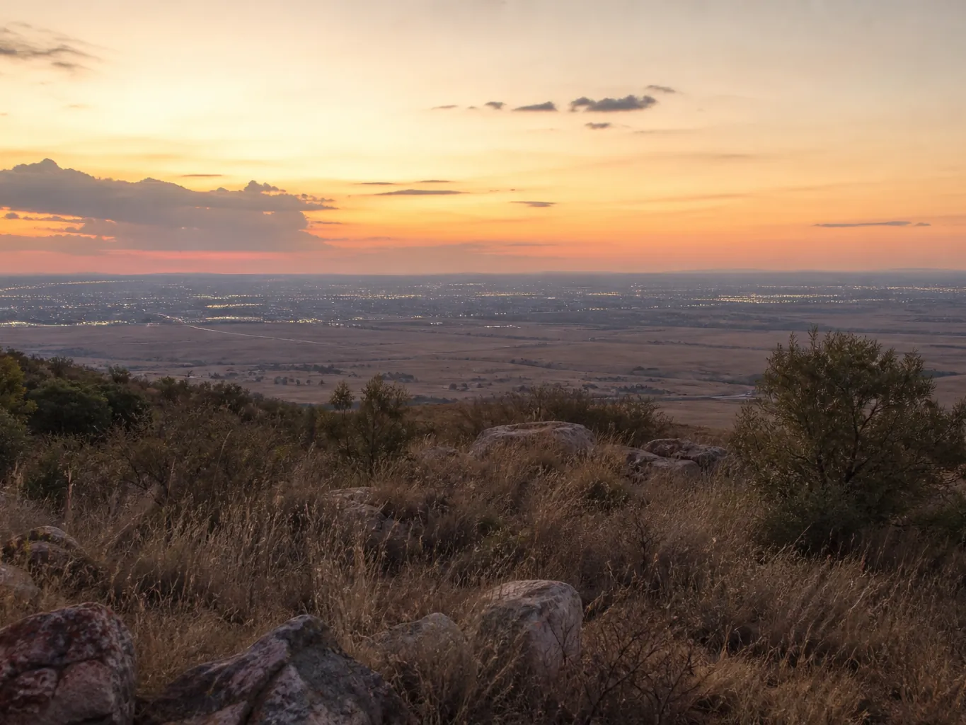 The Gauteng highveld at sunset with distant city lights